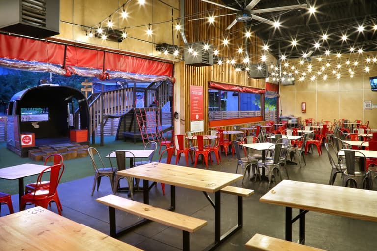 large indoor/outdoor patio seating overlooking play area